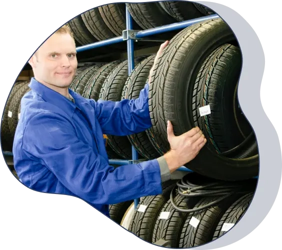 A mechanic holding a tire