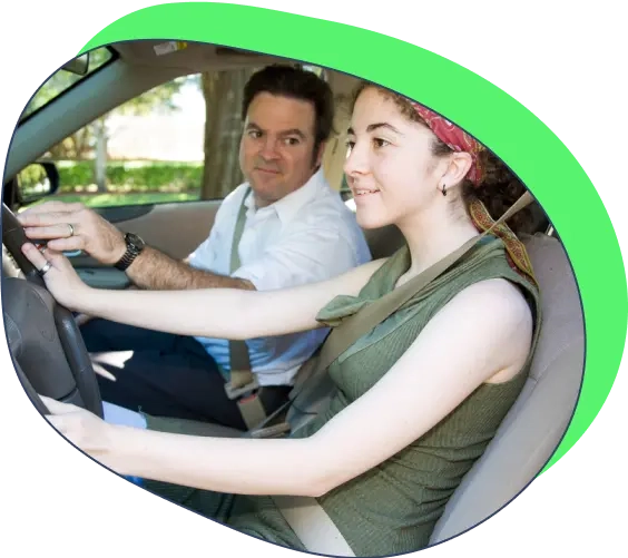 A girl having a driving class with an instructor