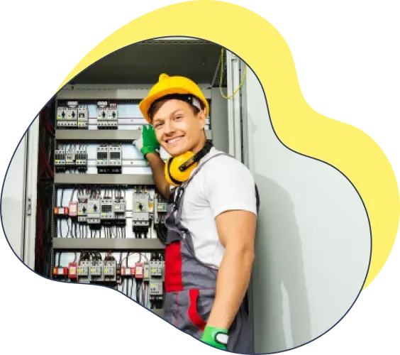 An electrician standing in front of an electrical panel
