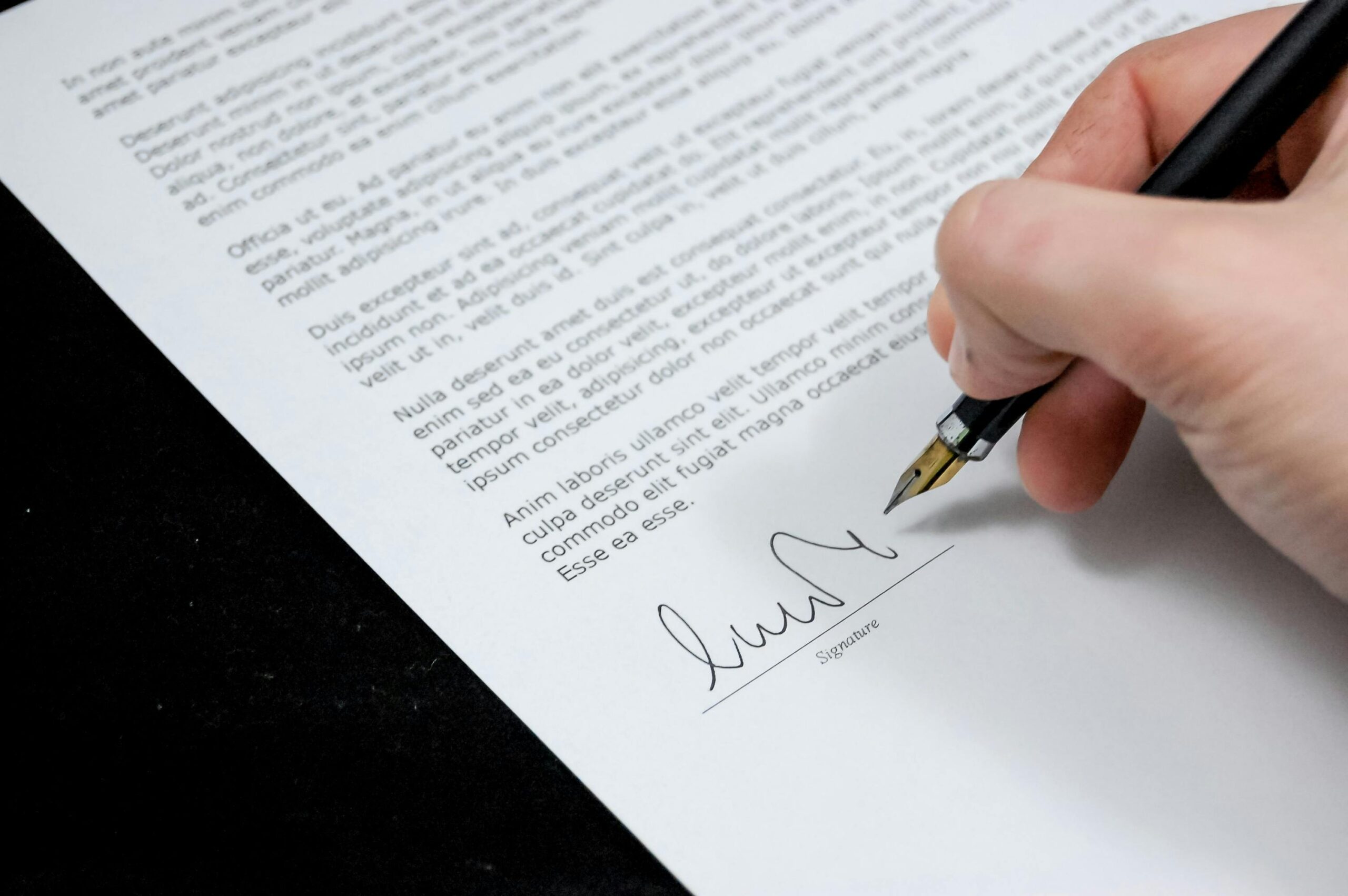 Signing the legal document to finalize the sale of a business 